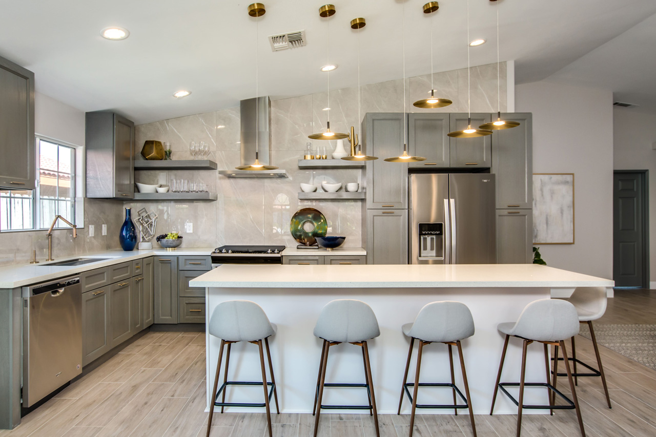 Grey kitchen with crisp white counters and full-height storage